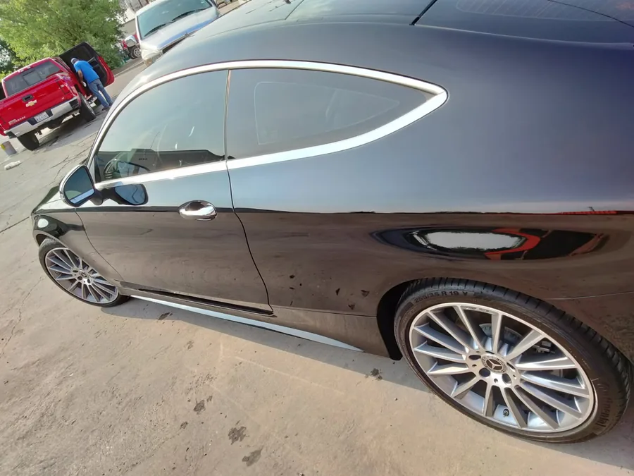 Black Mercedes-Benz C-Class coupe with mirror-gloss paint after correction in Slaton, TX